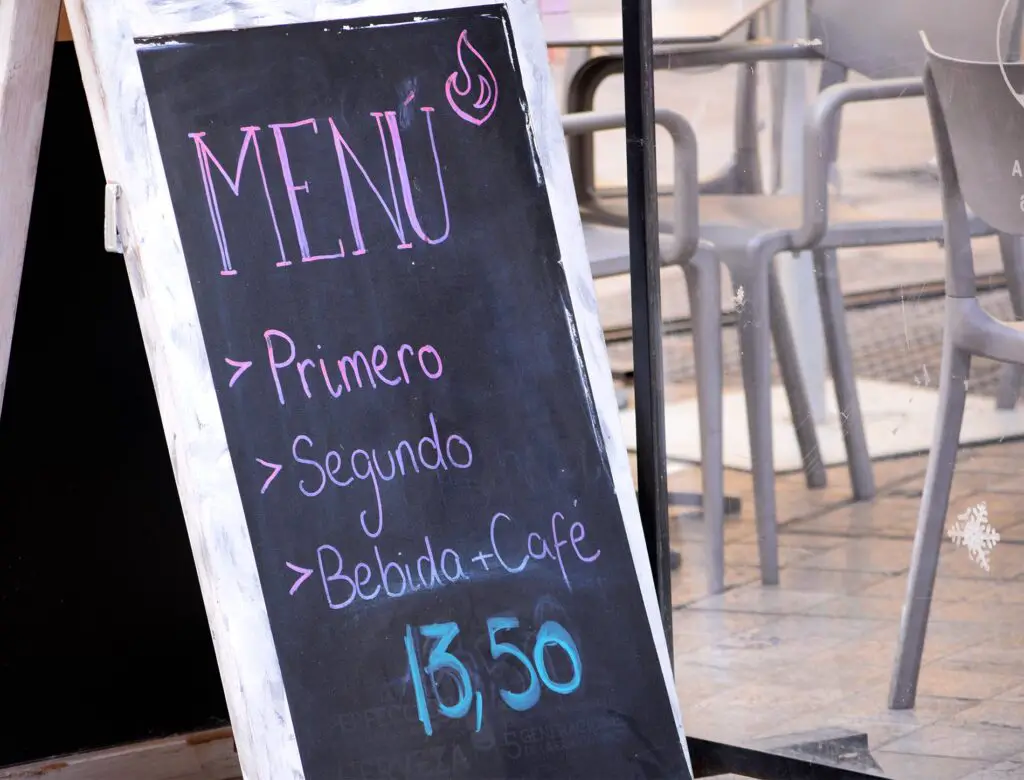 Menu of the day written on blackboad in front of a restaurant