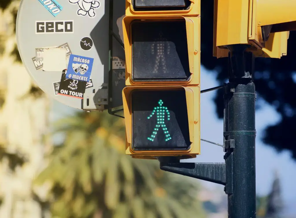 Pedestrian green crossing light illustrating the idea of walking in Malaga